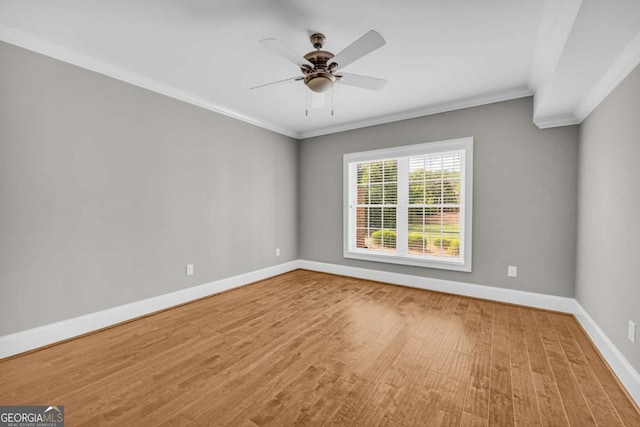 unfurnished room with baseboards, crown molding, a ceiling fan, and wood finished floors