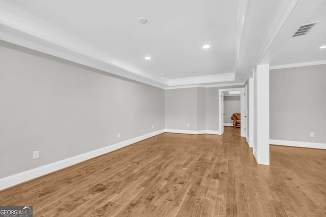 below grade area with crown molding, wood finished floors, baseboards, and recessed lighting