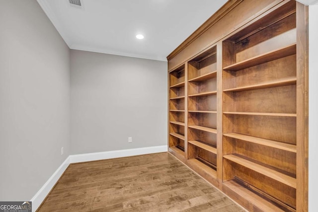 spare room featuring baseboards, wood finished floors, and recessed lighting
