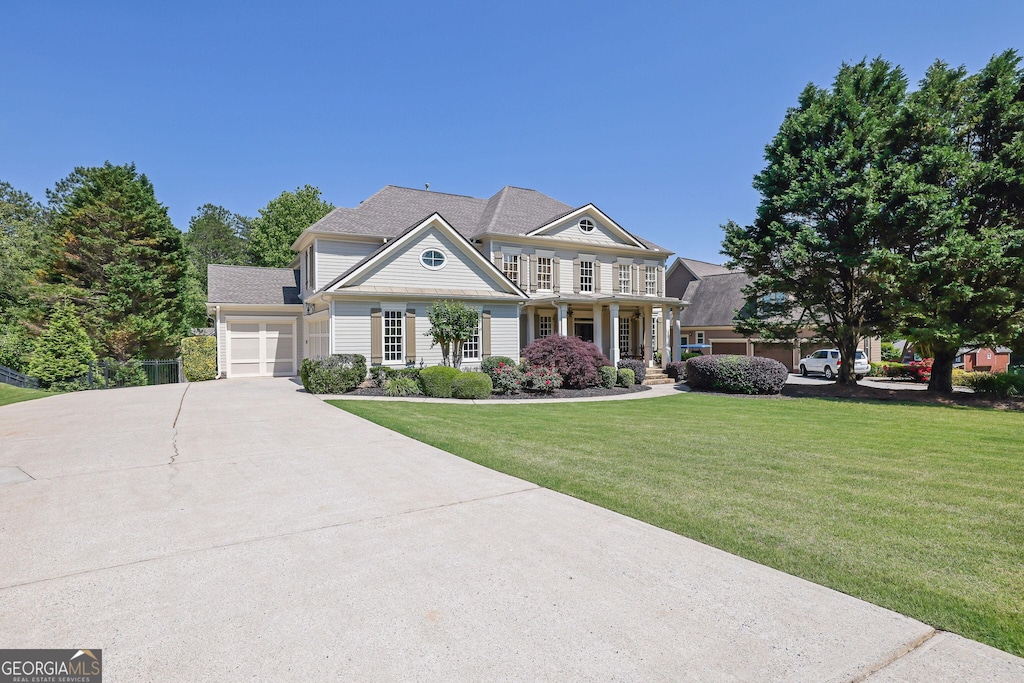 3735 Duckcove Way, Cumming, GA 30041 - view of front of home featuring concrete driveway, a garage, a front yard, and a porch