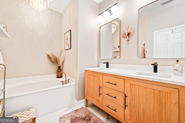 bathroom featuring double vanity, marble look tiles, and a bath