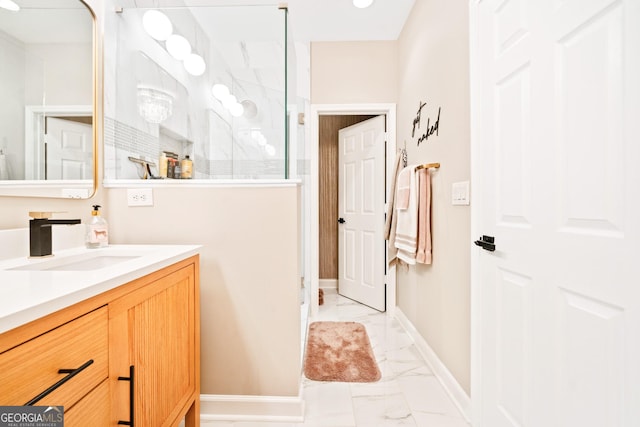 bathroom with marble look tiles, a walk in shower, baseboards, and vanity