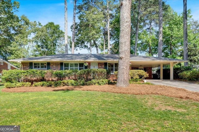 561 Sybil Ln SE, Marietta, GA 30067 - view of front of property featuring asphalt driveway, a front lawn, an attached carport, and brick siding