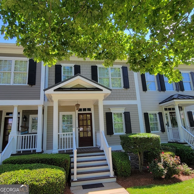 townhome / multi-family property with a porch