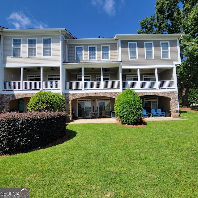 175 Lakeview Dr Apt 102, Eatonton, GA 31024 - back of house featuring ceiling fan, a lawn, and stone siding