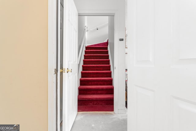 stairway featuring concrete flooring