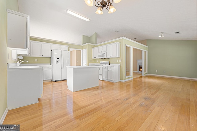 clothes washing area featuring a chandelier, light wood-style flooring, a sink, and baseboards