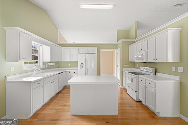 kitchen with white appliances, white cabinetry, a sink, and lofted ceiling