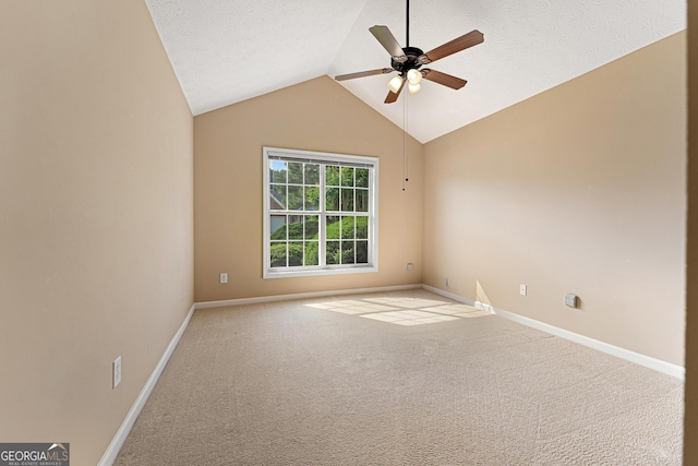 carpeted spare room with a ceiling fan, lofted ceiling, and baseboards