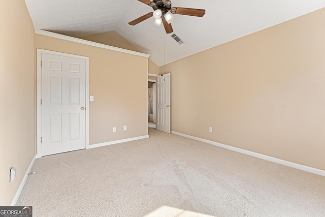 unfurnished bedroom with carpet, vaulted ceiling, baseboards, and a ceiling fan