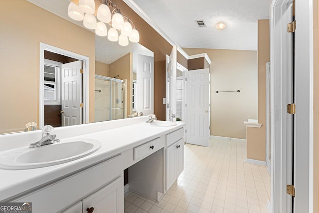 bathroom with a stall shower, double vanity, tile patterned floors, and baseboards