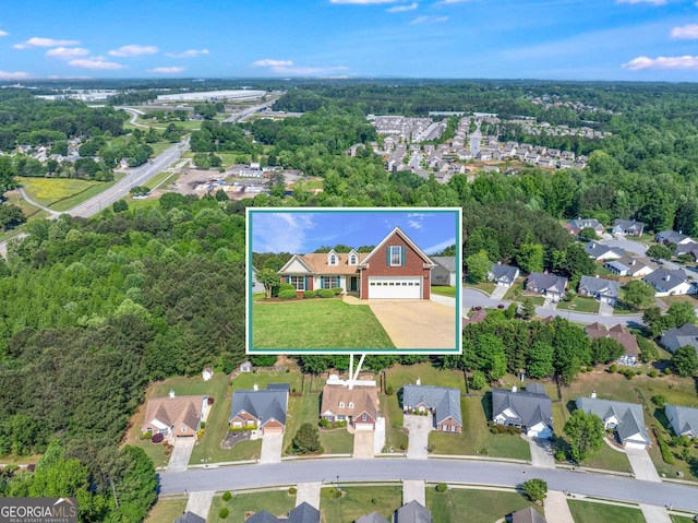 aerial view of property and surrounding area with property boundaries highlighted, a forest, and nearby suburban area