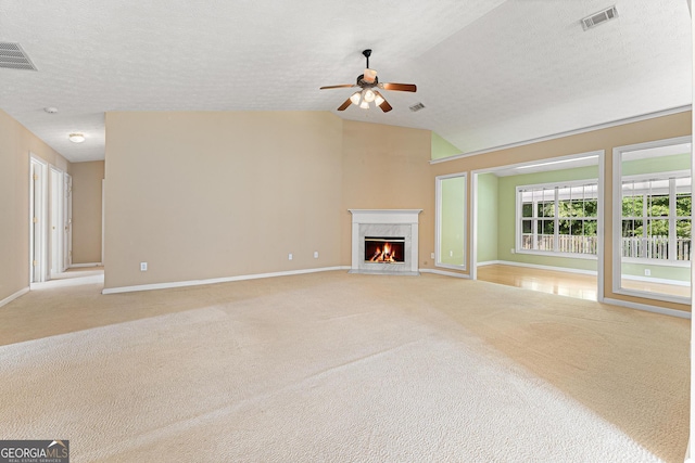 unfurnished living room featuring ceiling fan, light colored carpet, baseboards, a fireplace, and vaulted ceiling