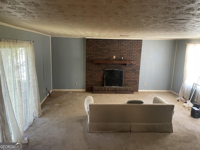 living room with carpet floors, a brick fireplace, baseboards, a textured ceiling, and crown molding