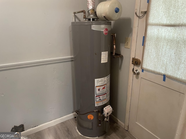 utility room featuring gas water heater