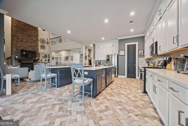 170 Oakleigh Manor Dr, Fayetteville, GA 30215 - kitchen with stainless steel appliances, a kitchen bar, a center island, open floor plan, and light countertops