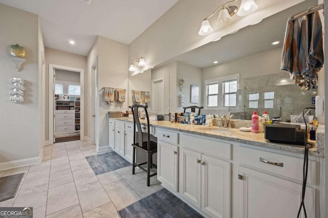 170 Oakleigh Manor Dr, Fayetteville, GA 30215 - full bathroom featuring vanity, walk in shower, baseboards, a walk in closet, and tile patterned flooring