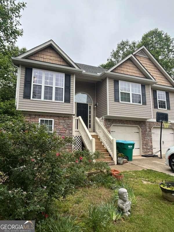 96 Moorings Run, Jasper, GA 30143 - split foyer home featuring an attached garage, concrete driveway, and stone siding