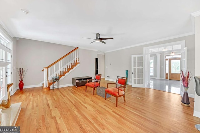 328 Broadmoor Way, Mcdonough, GA 30253 - living area featuring plenty of natural light, ceiling fan, light wood-type flooring, and crown molding