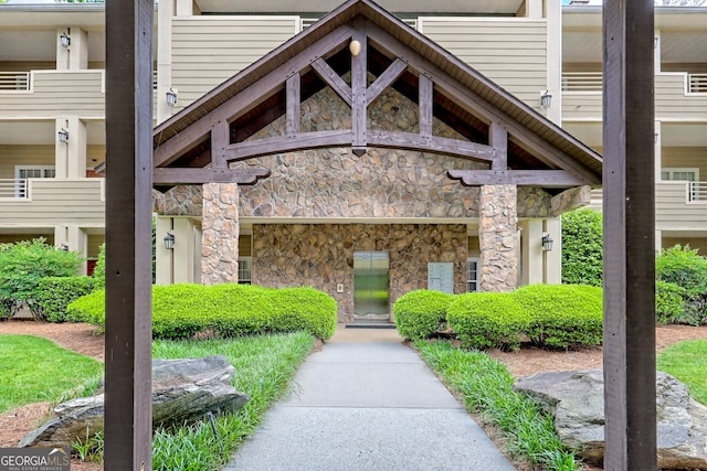property entrance featuring stone siding