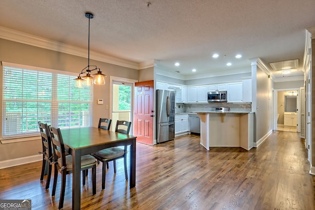 dining space with dark wood finished floors, ornamental molding, baseboards, recessed lighting, and a textured ceiling