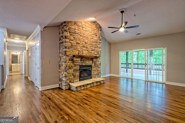 unfurnished living room featuring a ceiling fan, wood finished floors, baseboards, a fireplace, and vaulted ceiling