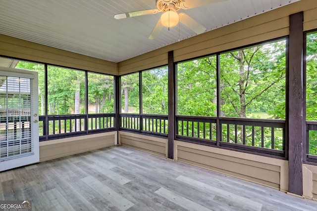 unfurnished sunroom featuring a ceiling fan