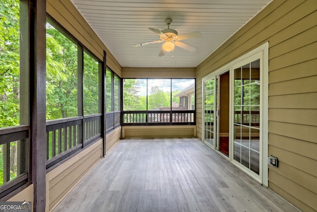unfurnished sunroom featuring a ceiling fan
