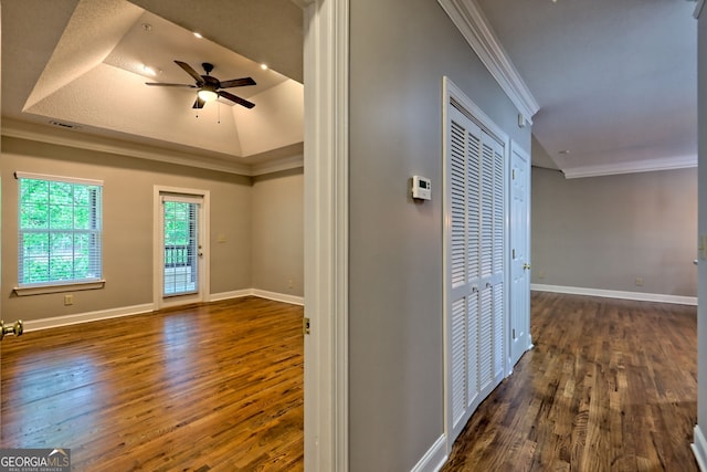 interior space featuring ornamental molding, wood finished floors, a ceiling fan, and baseboards