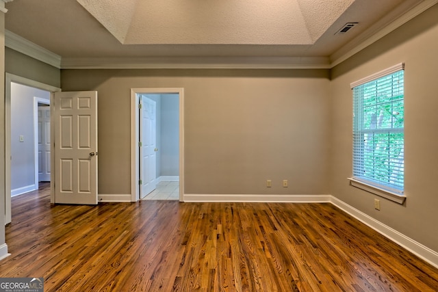 unfurnished room with ornamental molding, dark wood-style flooring, baseboards, and a textured ceiling