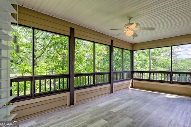 unfurnished sunroom featuring ceiling fan