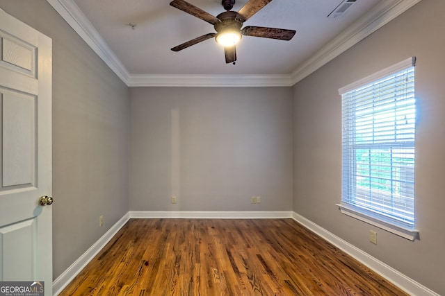 empty room featuring ceiling fan, dark wood-style floors, crown molding, baseboards, and fire sprinkler in ceiling