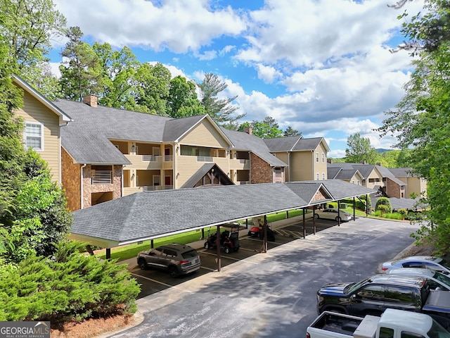 view of property with covered parking and a residential view