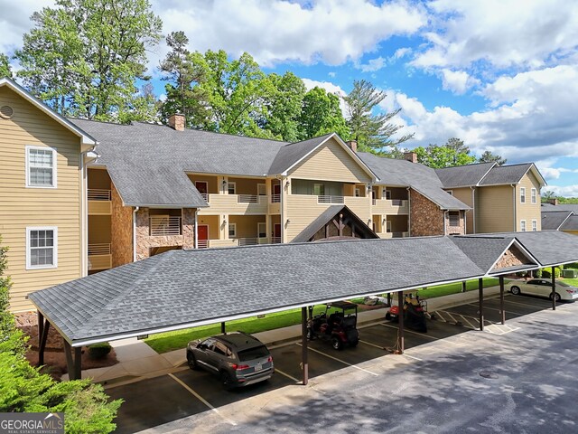 view of property with covered parking and a residential view
