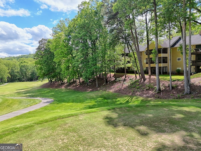 view of home's community featuring a lawn
