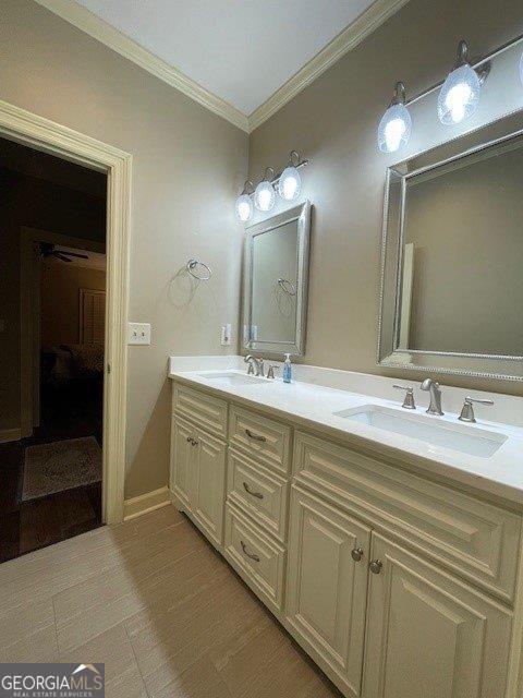 full bath featuring crown molding and double vanity