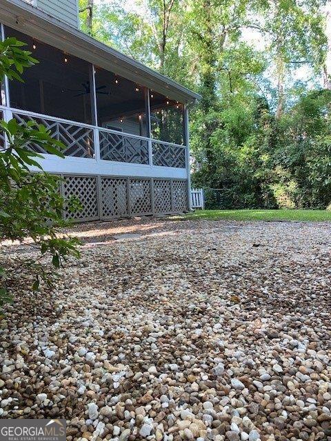 view of home's exterior with a sunroom