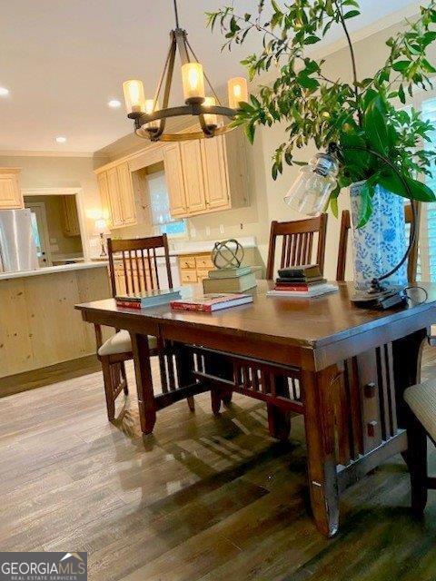 dining space with a chandelier, light wood finished floors, and recessed lighting