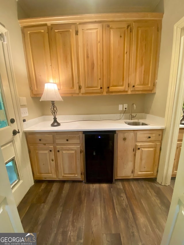 3132 Ingleside Ave, Macon, GA 31204 - kitchen featuring black dishwasher, a sink, light brown cabinetry, light countertops, and dark wood finished floors