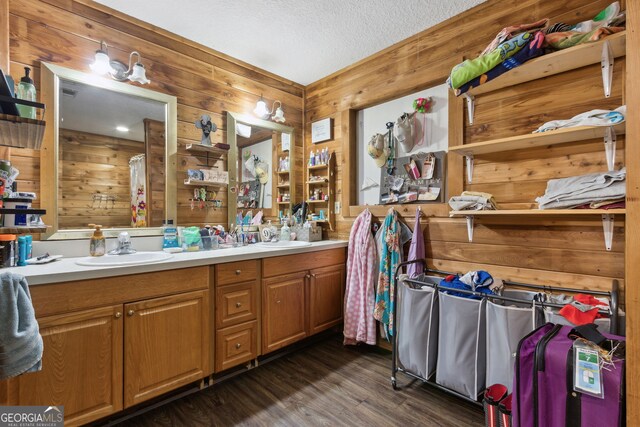 328 Willow Creek Rd, Folkston, GA 31537 - full bath with wood walls, a textured ceiling, double vanity, wood finished floors, and a shower