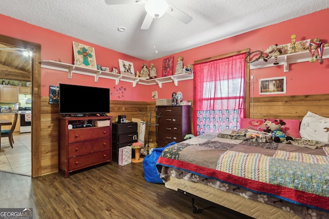 328 Willow Creek Rd, Folkston, GA 31537 - bedroom with wood finished floors, a textured ceiling, wooden walls, and ceiling fan