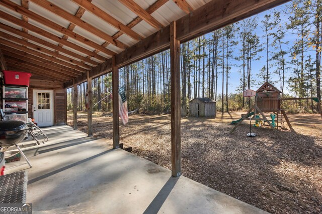 328 Willow Creek Rd, Folkston, GA 31537 - view of patio / terrace with a storage unit, a playground, and an outbuilding