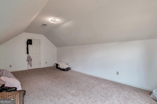 bonus room featuring carpet, vaulted ceiling, and baseboards