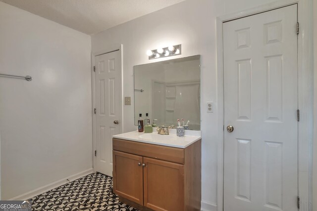 bathroom featuring baseboards and vanity