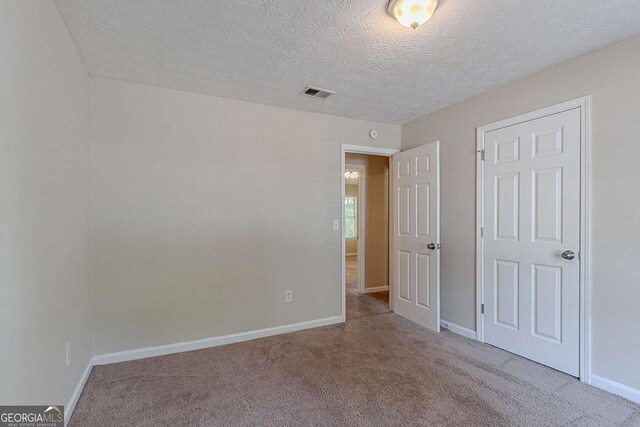 1363 To Lani Farm Rd, Stone Mountain, GA 30083 - unfurnished bedroom featuring carpet flooring, a textured ceiling, and baseboards