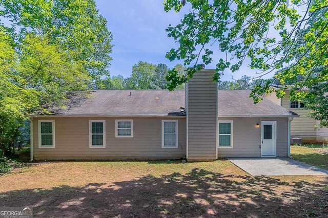 1363 To Lani Farm Rd, Stone Mountain, GA 30083 - back of property featuring a patio and a chimney