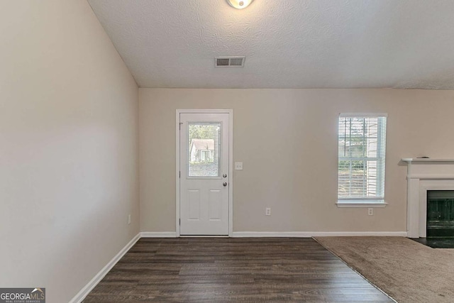 1363 To Lani Farm Rd, Stone Mountain, GA 30083 - entryway featuring healthy amount of natural light, dark wood-style floors, baseboards, and a textured ceiling
