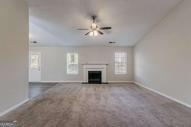 1363 To Lani Farm Rd, Stone Mountain, GA 30083 - unfurnished living room with carpet, ceiling fan, baseboards, and a fireplace