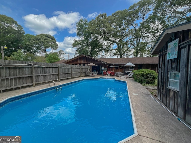 view of pool featuring a fenced backyard and a patio