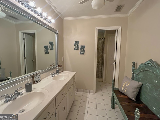 full bath with crown molding, a ceiling fan, tile patterned floors, double vanity, and baseboards
